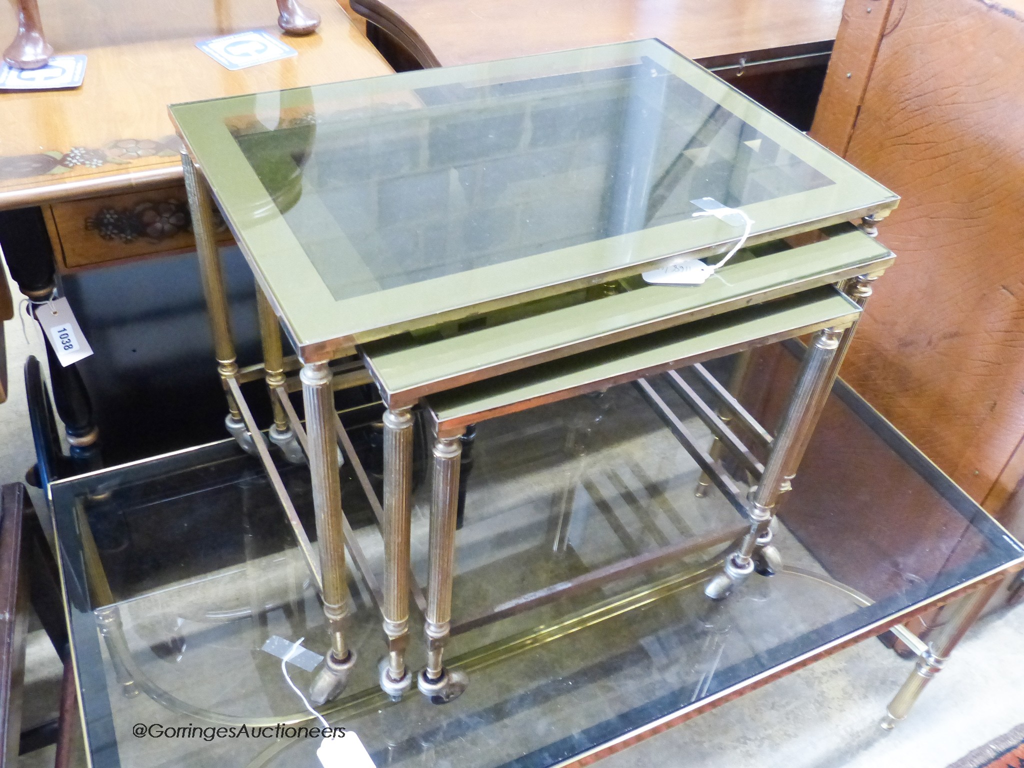 Two nests of gilt metal and glass tables and a similar coffee table.